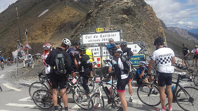 Riders throng the summit of Col du Galibier.