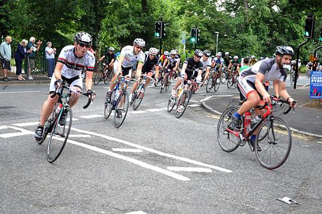 Riders pass by cheering crowds in Byfleet.