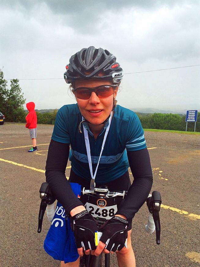 The victorious face of a woman who has just ridden 98.86 miles. Photo: Olly Townsend