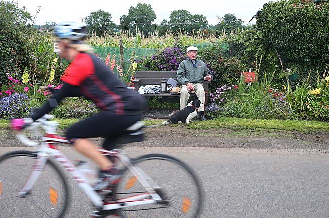 Riders are cheered on by crowds - and the usual one man and his dog. Photo: Mal McCann