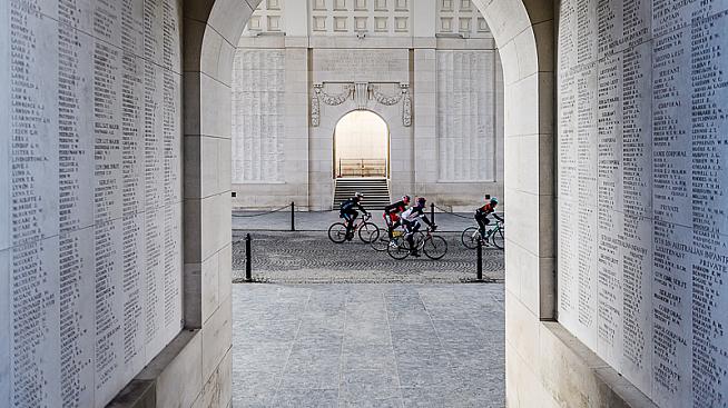 Cyclists pass under the Menin Gate war memorial in Ypres. Credit: Etixx Classics Tour