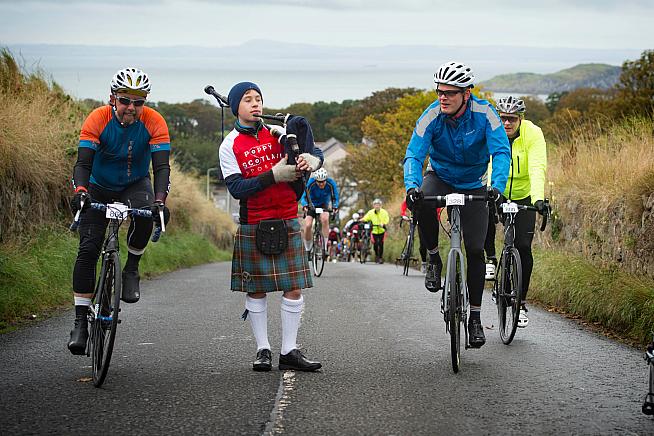 A piper encourages riders on the 'King/Queen of the Heugh' hill climb challenge.