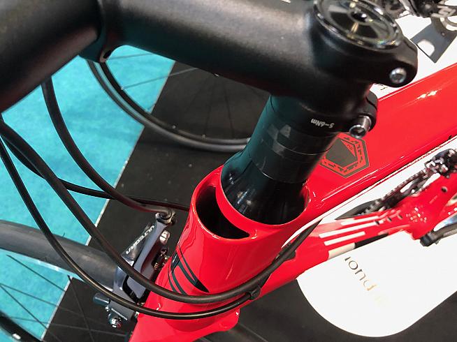 The unsightly gap at the front of the headtube is for routing cables when fitted with the aero integrated bars.