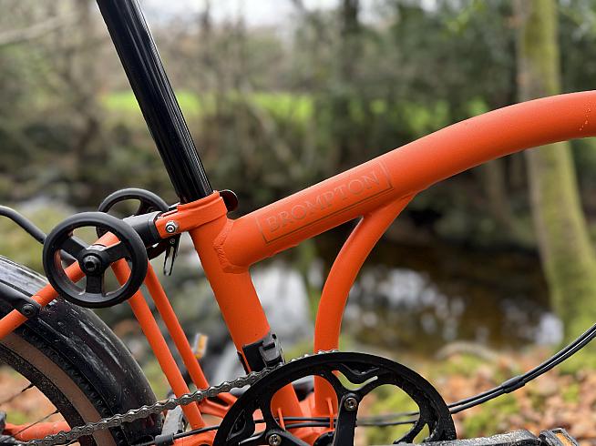 The rear triangle and wheel fold beneath the bike...